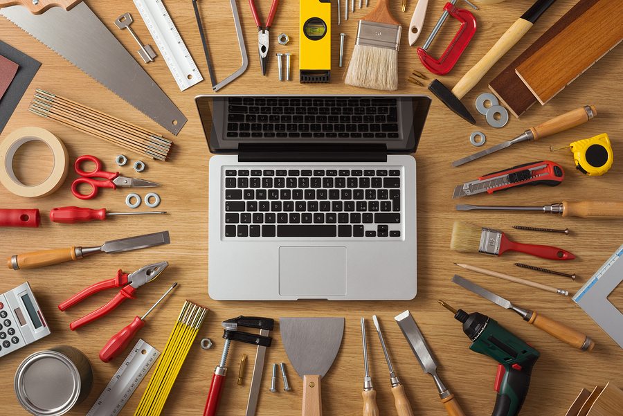 copywriting - open laptop surrounded by stationary tools