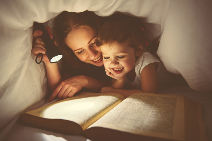 storytelling - a mother reading a story to her child