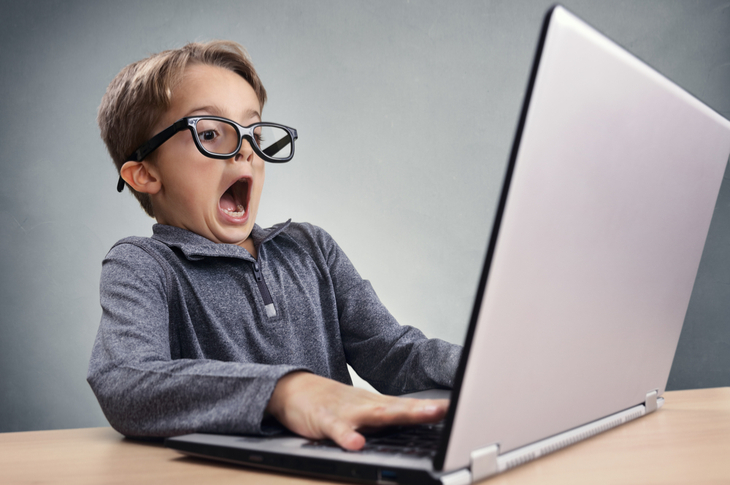 content marketing practices to avoid - Shocked and surprised boy on the internet with laptop computer